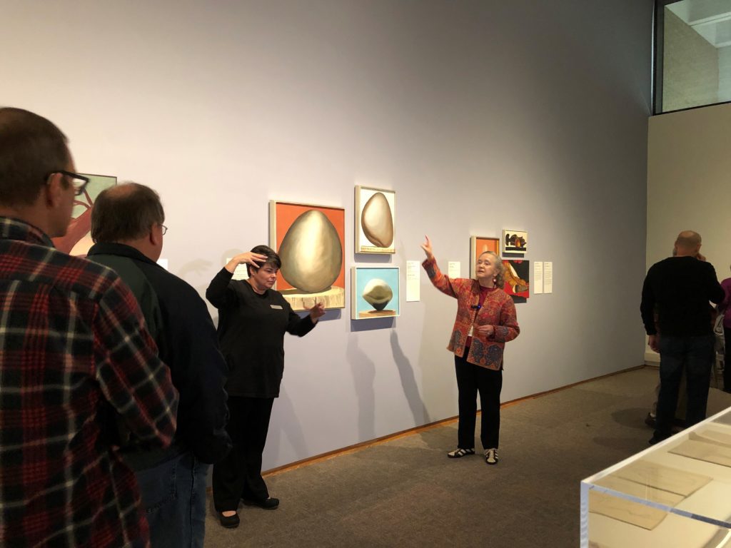 A docent accompanied by an American Sign Language interpreter leads a tour in a Georgia O’Keeffe special exhibition.