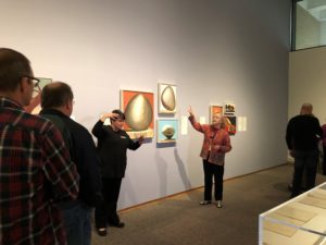 A docent accompanied by an American Sign Language interpreter leads a tour in a Georgia O”™Keeffe special exhibition.