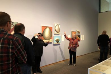 A docent accompanied by an American Sign Language interpreter leads a tour in a Georgia O”™Keeffe special exhibition.