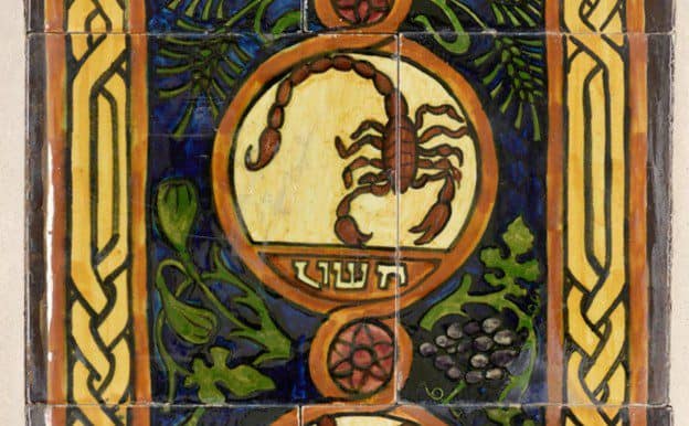 A ceramic tile artwork featuring a painted scorpion denoted with Hebrew characters.