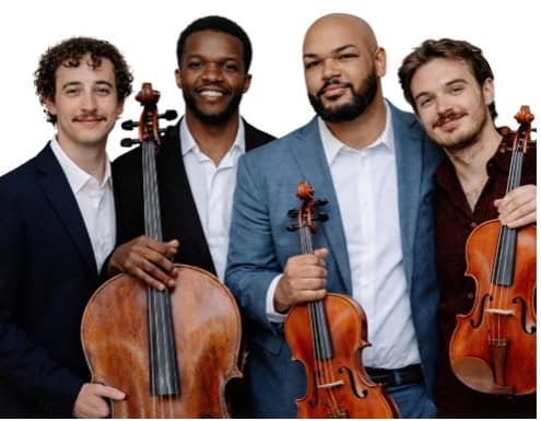 Four men, three holding stringed instruments by the neck, stand close together and look out at the viewer.
