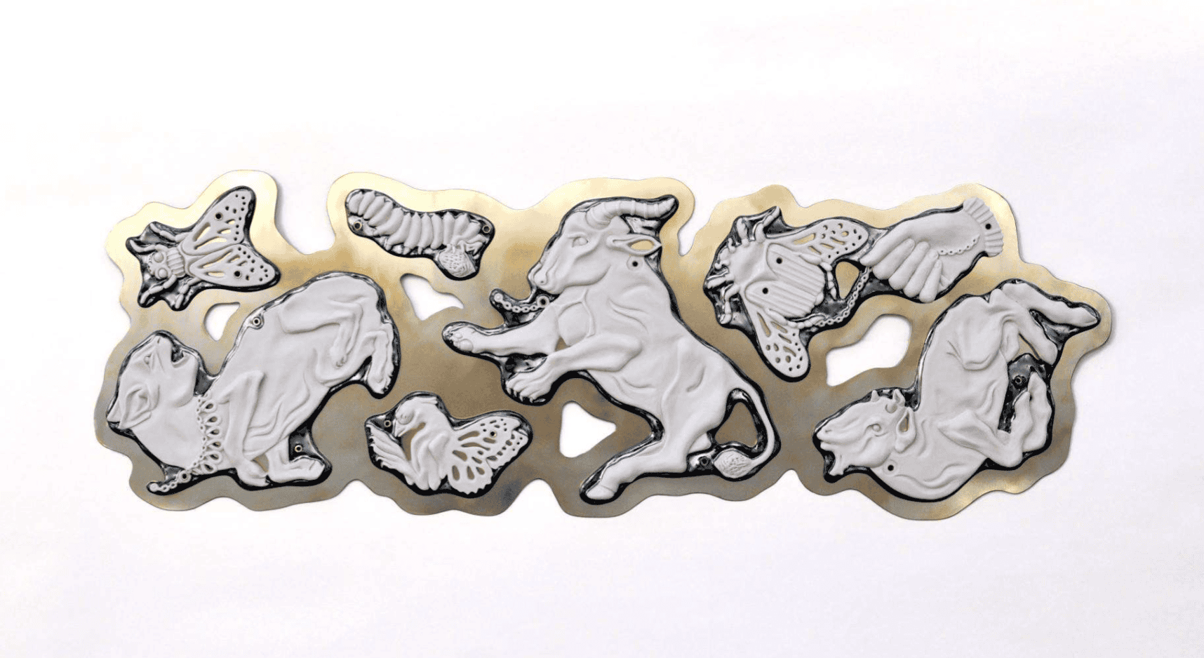 Clay relief sculpture featuring an assortment of white animals with a gold border glaze in between them.