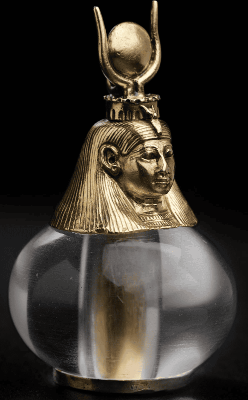 Pendant of a gold head topped with an elaborate headdress attached to a clear, somewhat flattened sphere.