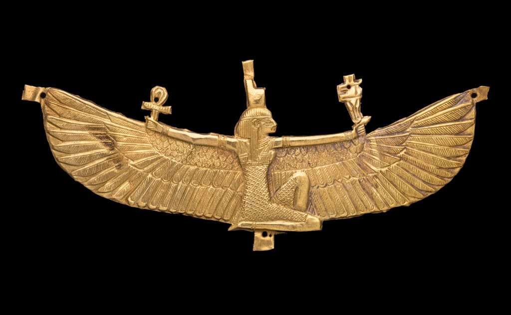 A golden pendant of a female goddess figure with wide, open wings expanded across.