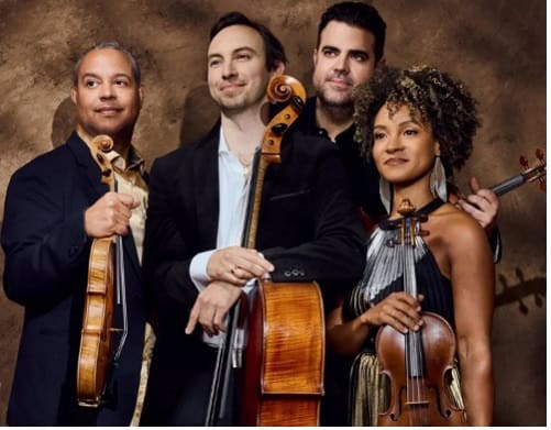 Three men and one woman hold stringed instruments and look out to the left.